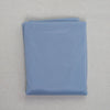 A folded light blue sheer chiffon fabric drape for weddings and events.