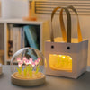 A handmade LED tulip night light in a white box with wooden handles, featuring glowing pink tulips inside.