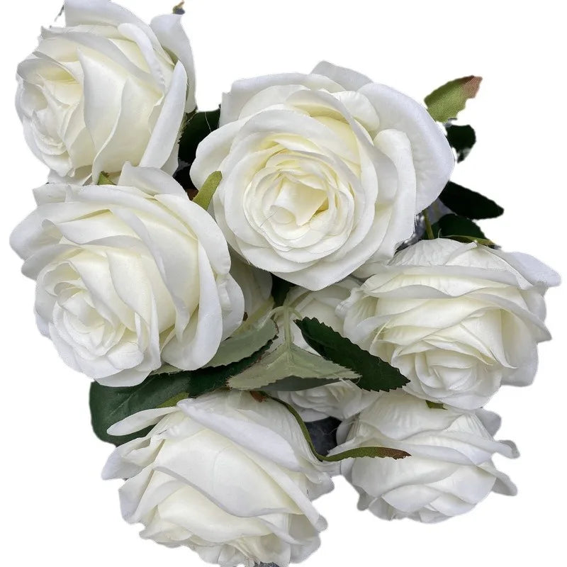 A bouquet of nine white silk roses used for weddings and home decor