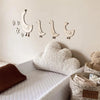 Handcrafted wooden goose wall art with floral accents displayed on a white wall above a white sofa.