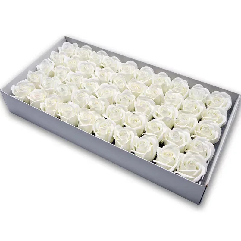 A rectangular box filled with numerous white artificial rose flower heads.