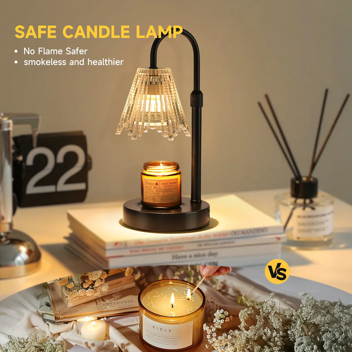 A black candle lamp with a glass shade sits on a white surface next to candles and books.
