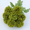 A bouquet of artificial green hydrangea and camellia flowers with green leaves.