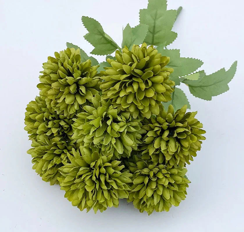 A bouquet of artificial green hydrangea and camellia flowers with green leaves.