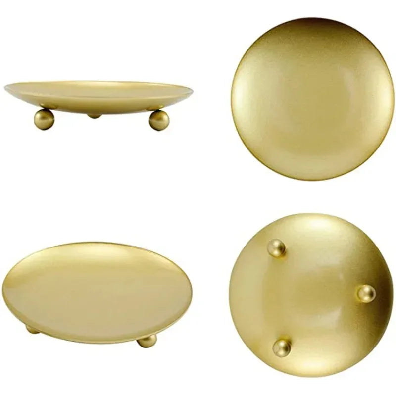 A set of elegant gold iron candle holder trays, including a shallow oval tray and a round plate with decorative studs.