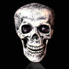 A realistic white skull carved from bone used for Halloween graveyard decor.