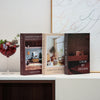 A set of three hardcover books titled Modern Harmony Curated Spaces and Calm by Design displayed on a white surface.