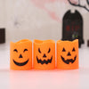 A set of six orange battery-powered LED Halloween candles with carved jack-o'-lantern faces.