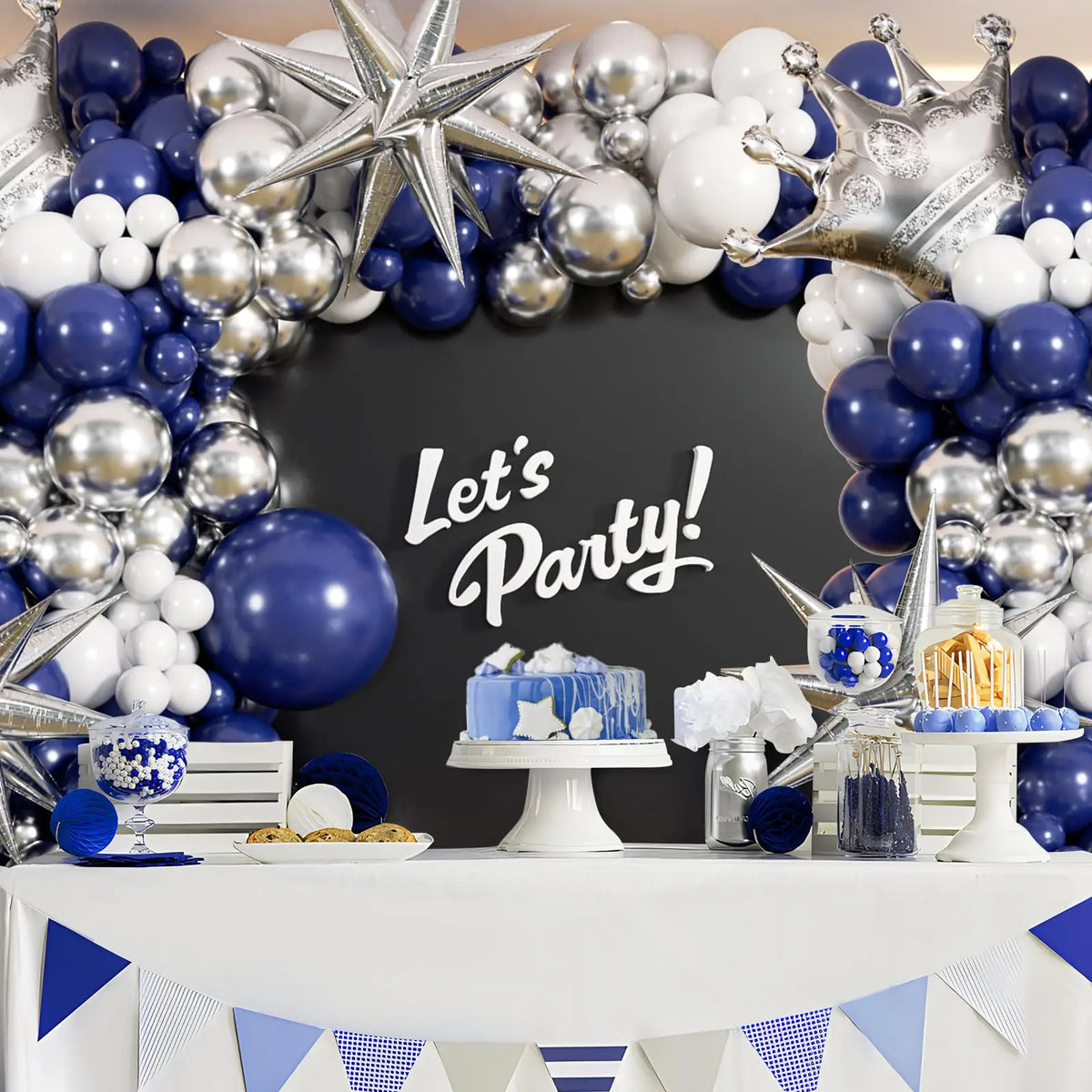 A balloon garland arch featuring navy blue and silver balloons decorating a table setup for a party.