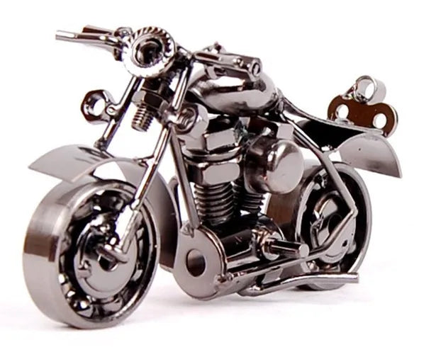 A handcrafted metal motorcycle model featuring chrome details and a vintage diecast display piece.