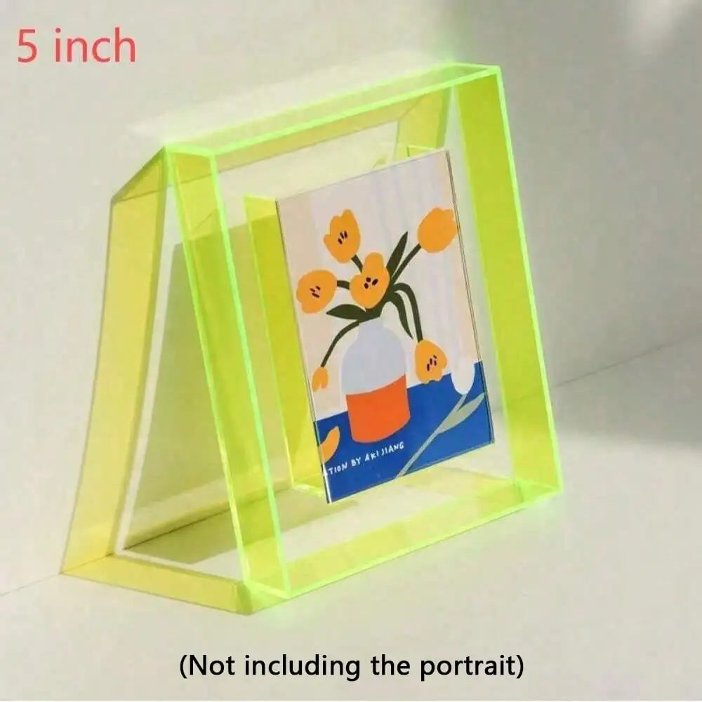 A clear acrylic photo frame with a yellow frame and a message board featuring an orange flower design.