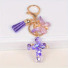 Gold and purple resin cross with a butterfly charm keychain