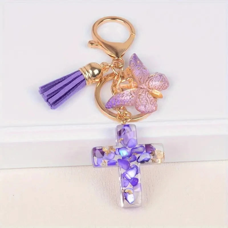 Gold and purple resin cross with a butterfly charm keychain