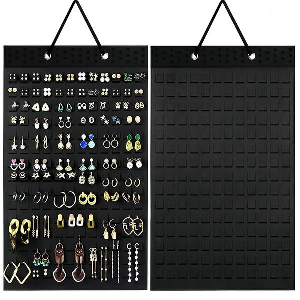 Black wall mounted felt earring organizer display with numerous pairs of earrings organized in compartments