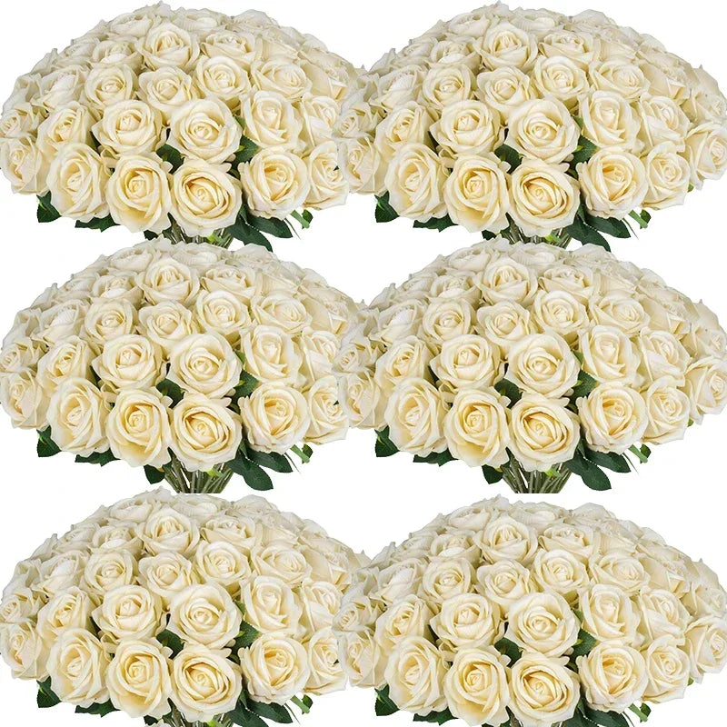 A collection of white artificial silk roses arranged in bouquets for table decor.