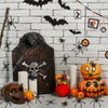A display of realistic mini plastic spiders and a carved pumpkin for Halloween decor.