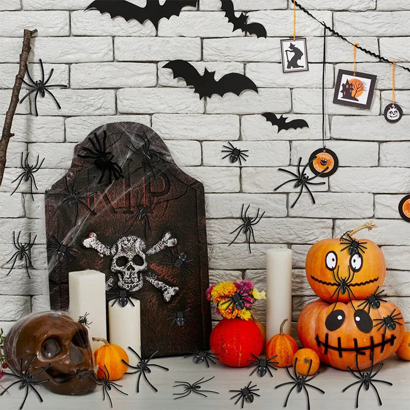 A display of realistic mini plastic spiders and a carved pumpkin for Halloween decor.
