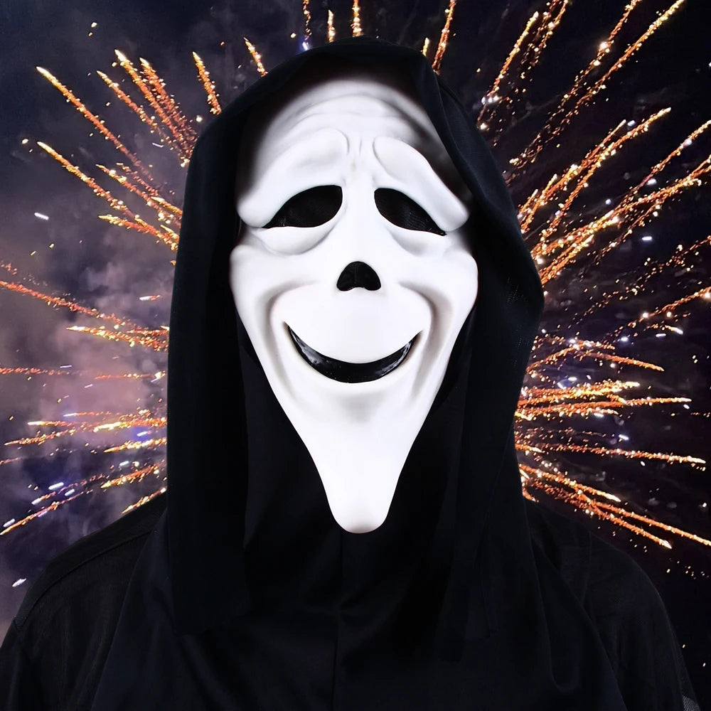 A white screaming skeleton horror mask with a black hood is shown against a background of bright fireworks.