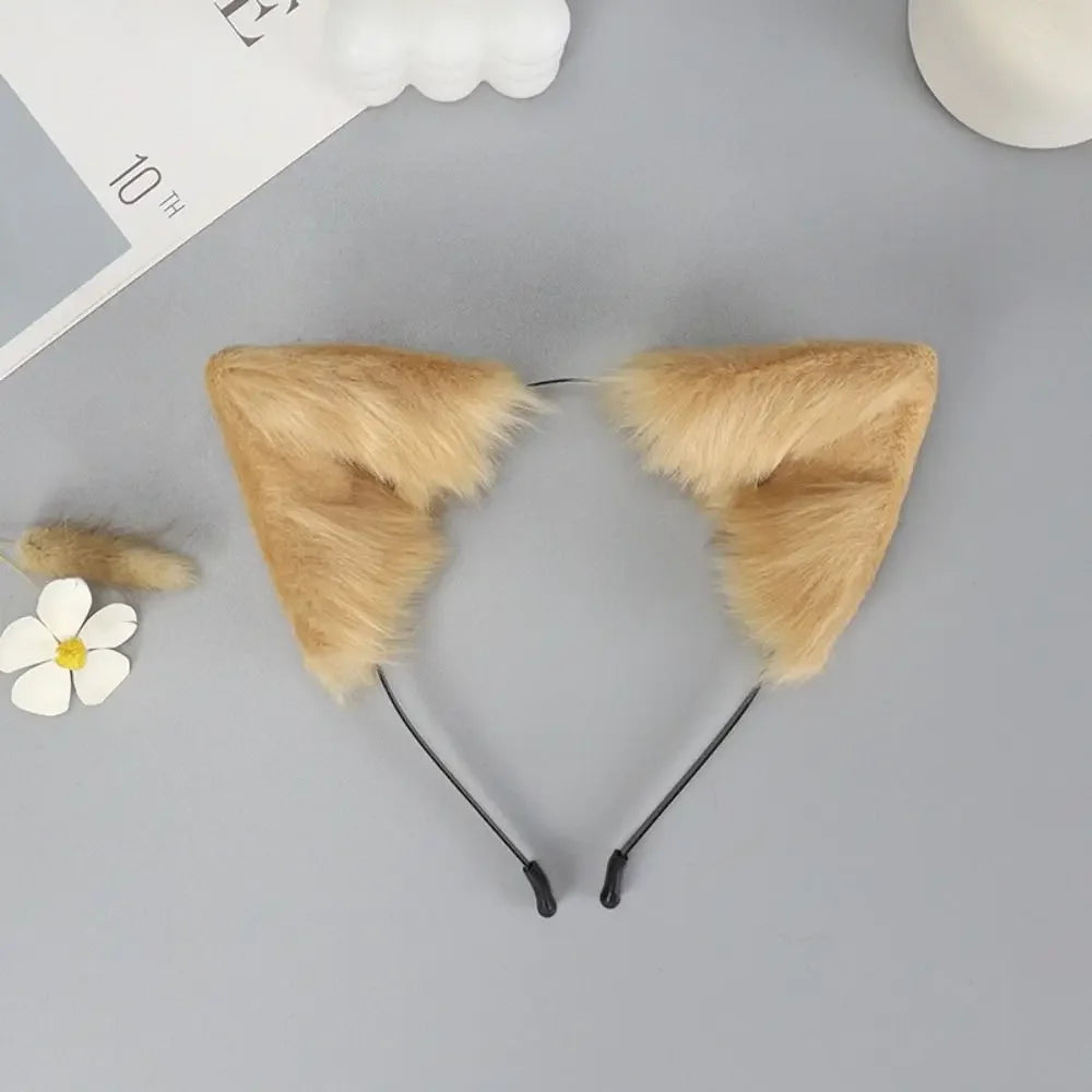 A pair of fluffy, tan fox ears headband with black straps displayed on a gray surface.