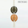 Two layers of macrame hat organizers featuring wooden dowels in olive green and terracotta tones