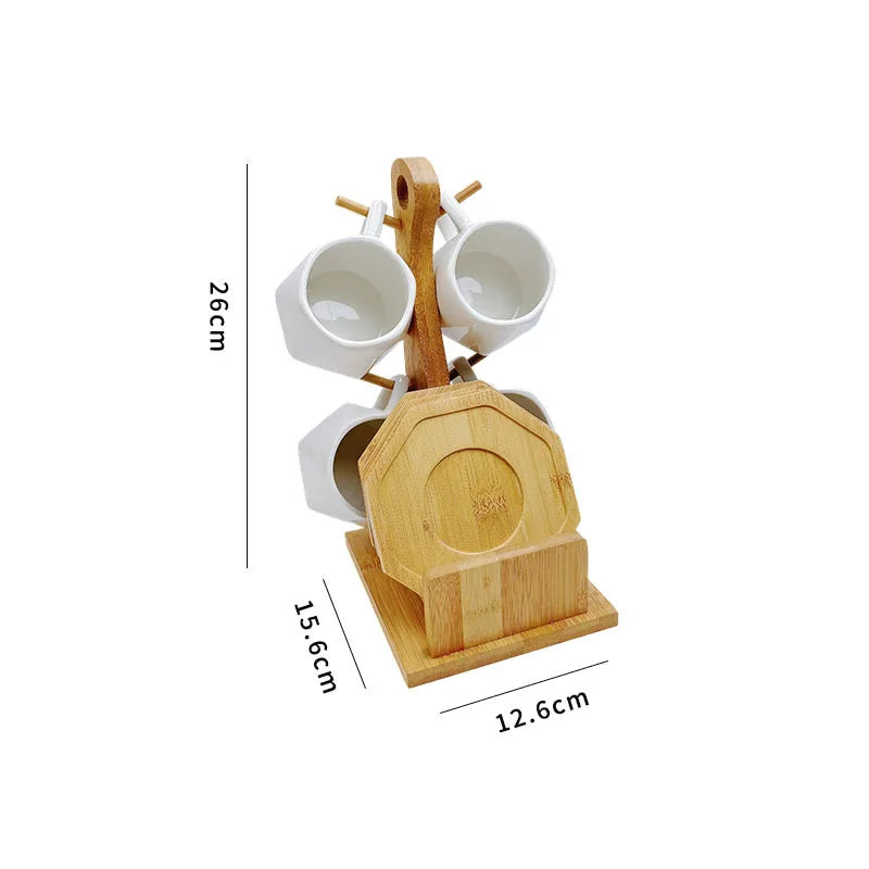 A ceramic coffee mug set with white mugs and a wooden bamboo stand for display.