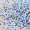 A pile of faceted bicone glass beads in mixed light blue and silver colors for jewelry making