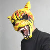A close-up of a yellow and orange bloody tiger horror latex mask being worn by a person.