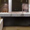 A modern bathroom vanity featuring a rectangular sink and a decorative tile backsplash.