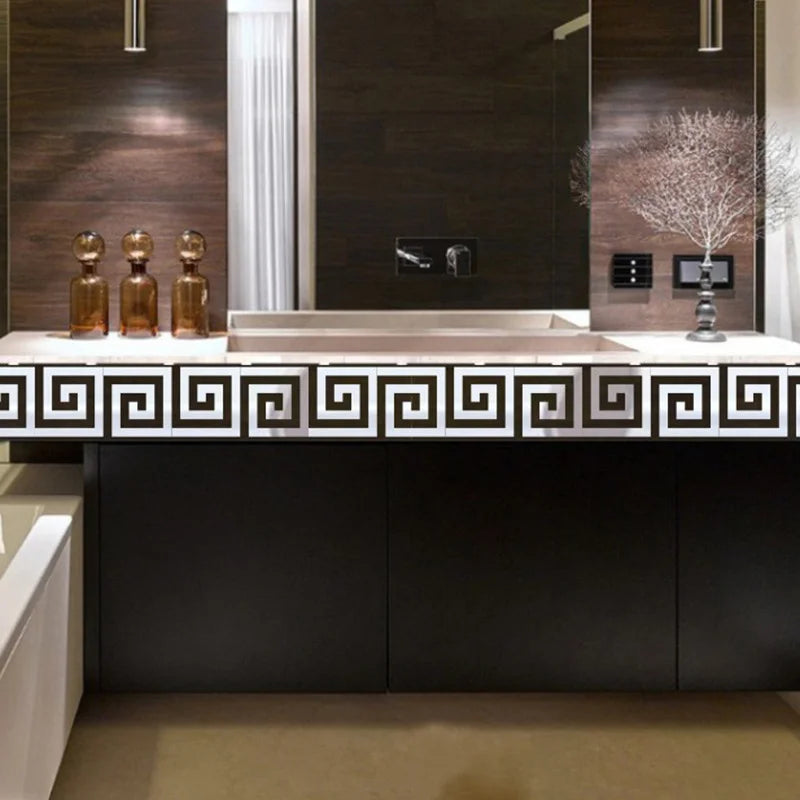 A modern bathroom vanity featuring a rectangular sink and a decorative tile backsplash.