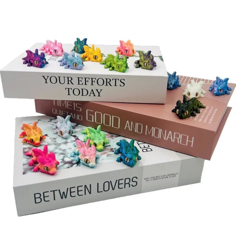 A collection of colorful articulated baby dragon figurines displayed in open boxes with text related to efforts and love.