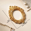 Vintage gold DIY shadow box frame with pearl detailing and a pearl strand shown on a light background.