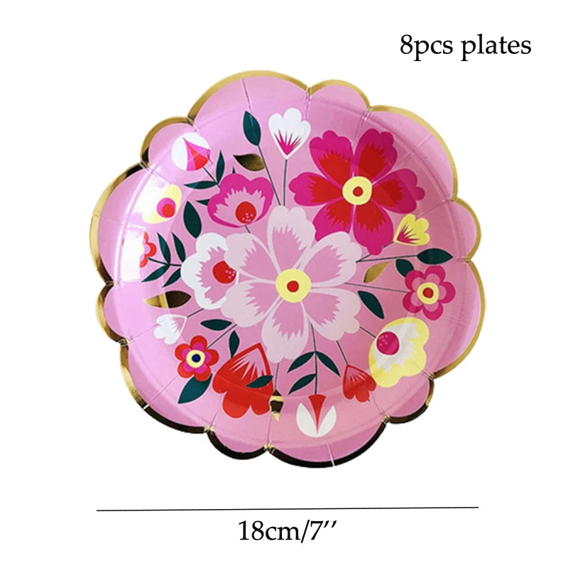 Eight pink floral disposable plates with red and green accents.