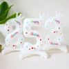 A white foil balloon shaped like the number 32 with a crown design and birthday text.