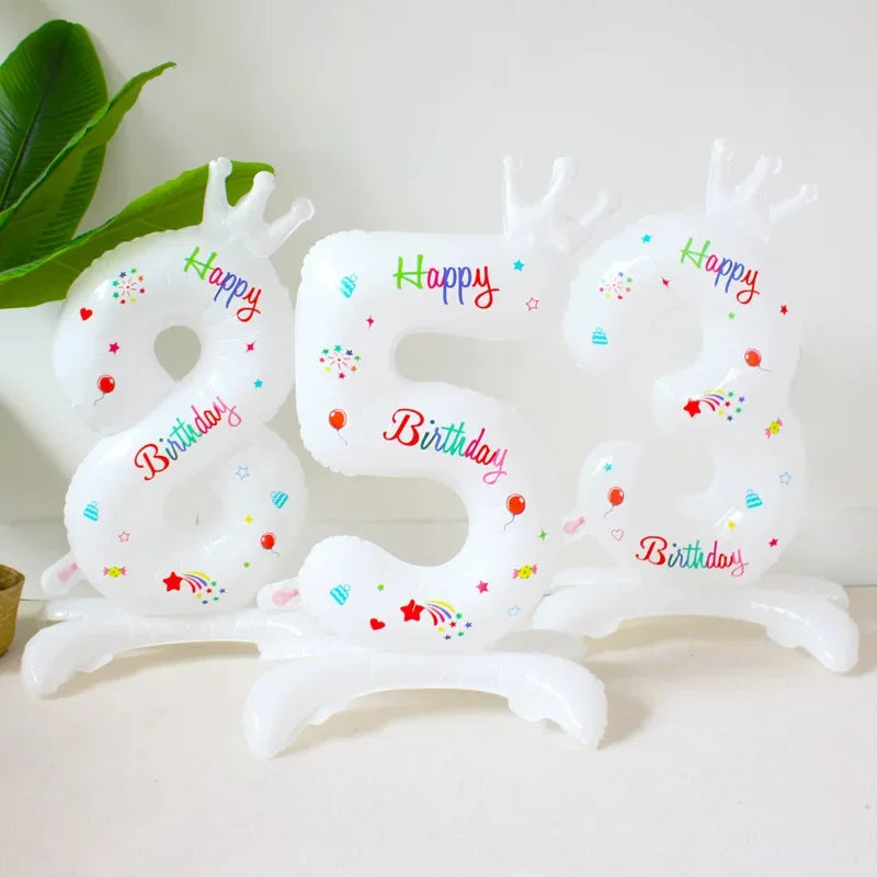 A white foil balloon shaped like the number 32 with a crown design and birthday text.
