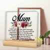 A personalized acrylic keepsake plaque with a wooden base featuring a floral design and a heartfelt message for Mom