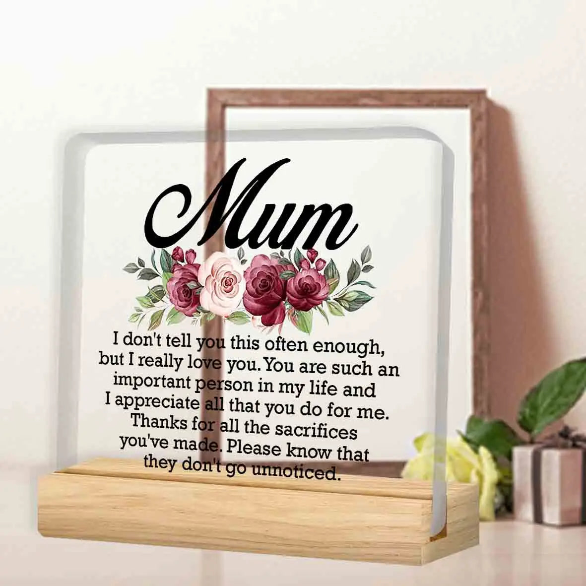 A personalized acrylic keepsake plaque with a wooden base featuring a floral design and a heartfelt message for Mom