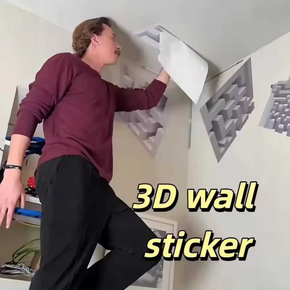 A person is demonstrating a 3D wall sticker featuring an impossible maze cube pattern on a white wall.