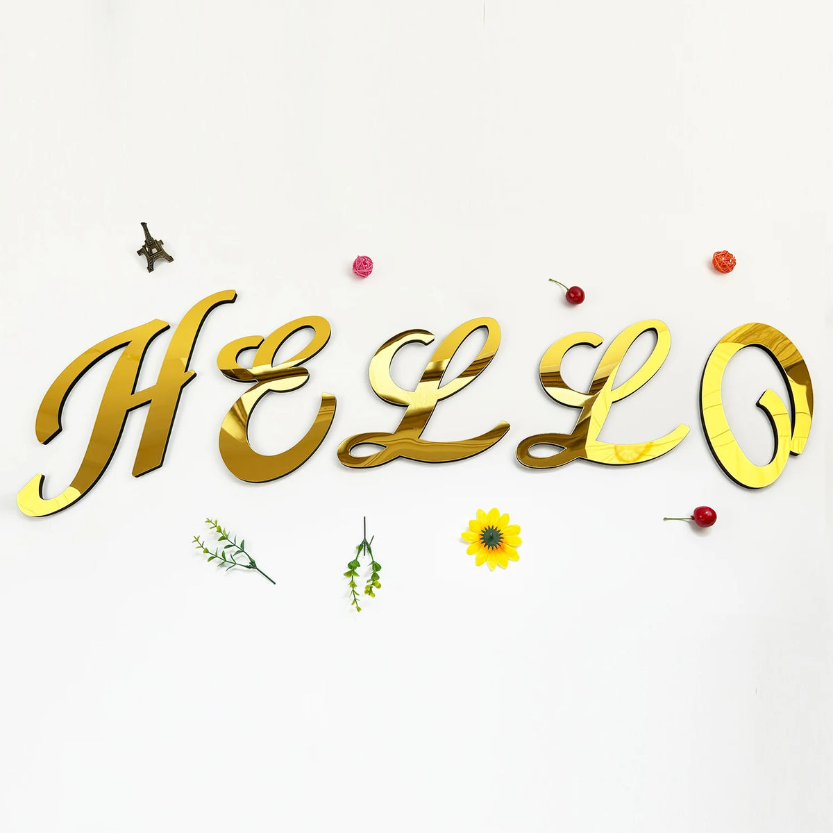Gold 3D acrylic letter wall stickers spelling HELLO decorated with small floral elements