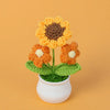 Hand woven crochet orange and yellow flowers in a white pot