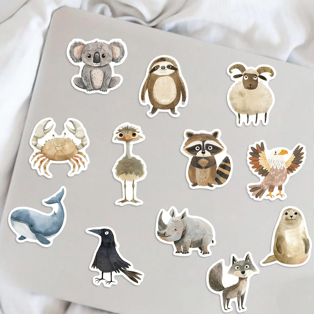 A collection of assorted animal stickers featuring various wildlife designs on a gray surface.