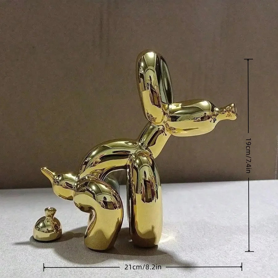 A shiny gold balloon dog sculpture in a squatting pose, displayed against a neutral background.