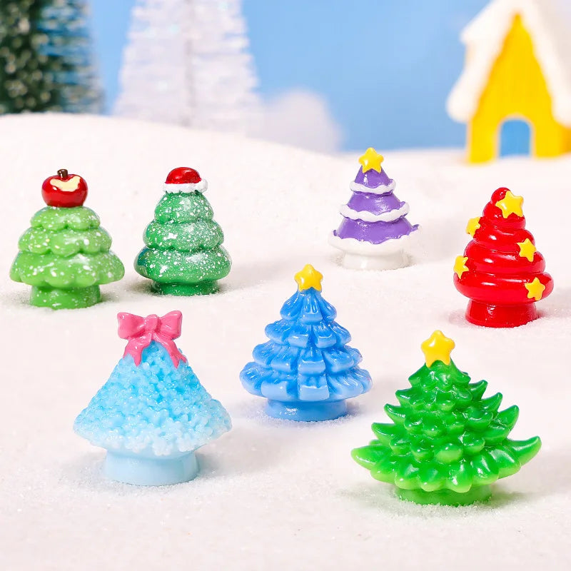 A collection of colorful mini 3D Christmas tree resin charms in various shades of green, red, purple, and blue resting on whi