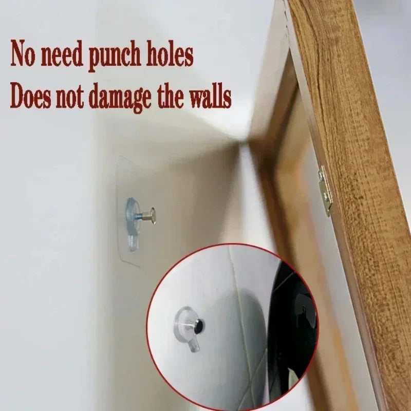 Close-up view of strong adhesive wall hooks being installed on a white wall, demonstrating no need for punch holes.