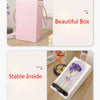 A pink box with a lid shows the inside of a beautiful box containing a rose crystal flower in an illuminated glass dome.