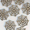 A collection of intricately cut wooden spider web ornaments in a natural wood tone.