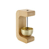 A wooden doorbell featuring a brass chime suspended by a string, mounted on a light wood frame.
