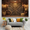 A rustic wooden backdrop featuring a weathered door and crossed beams, decorated with hay and wooden wheels.