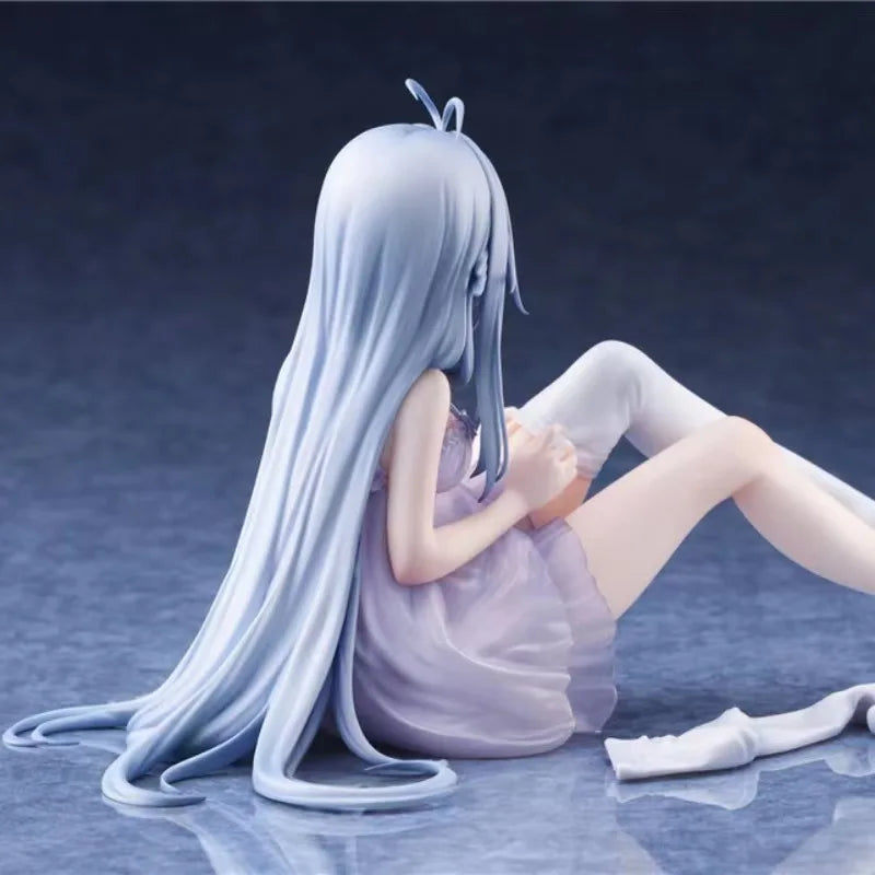 A light blue anime girl figurine with long hair sitting down on a reflective surface.