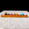 A set of natural crystal solar system planet balls arranged in a row on an orange wooden base.