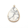 A teardrop-shaped pendant charm made of white marble with gray veining and a gold-colored bail.